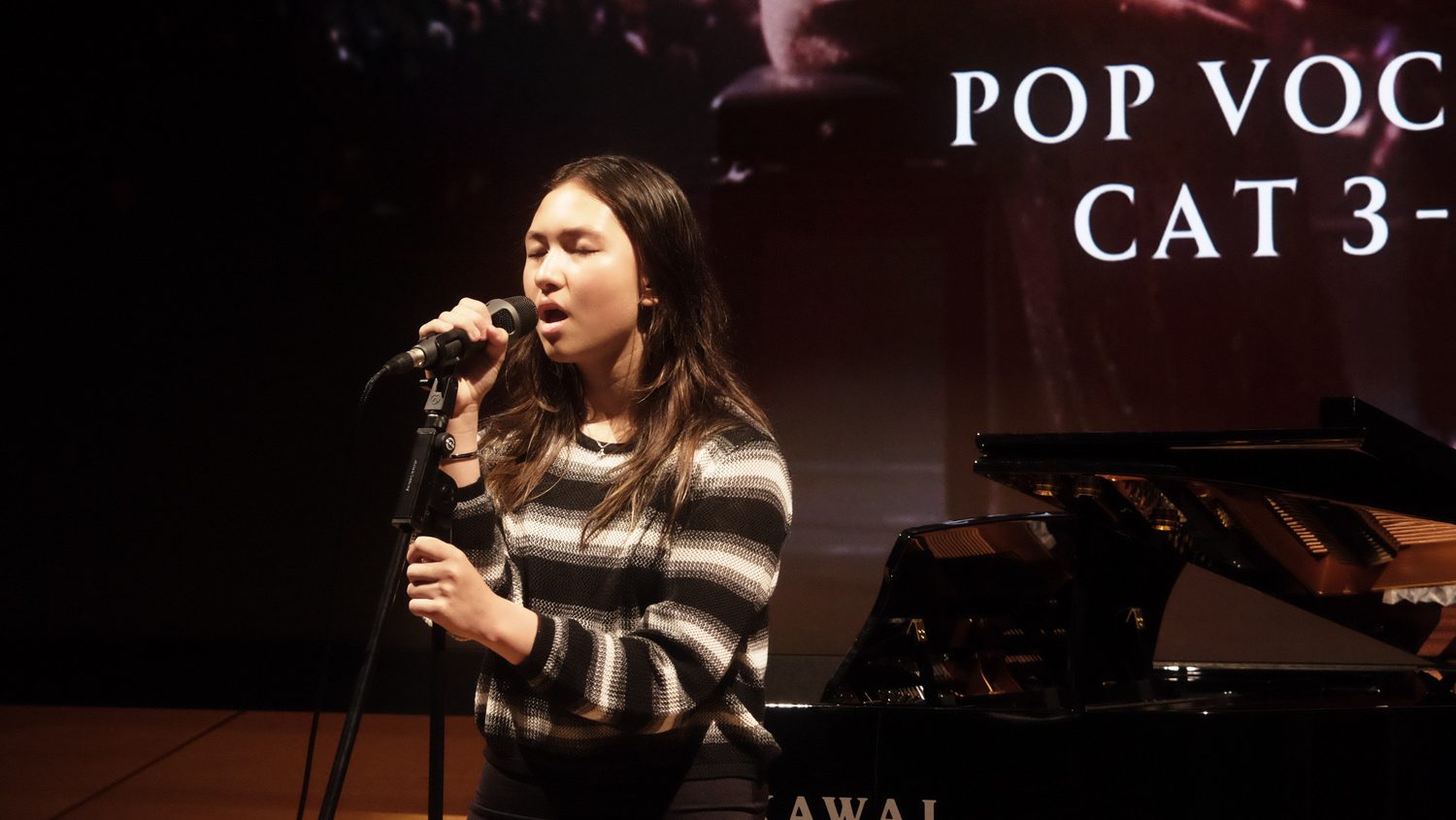 Young vocalist performing at the Rising Virtuoso Grand Finals